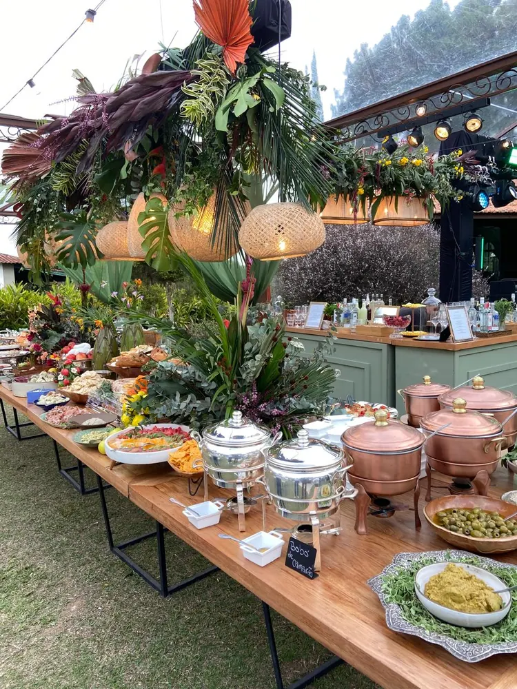 Bufê de evento ao ar livre com panelas de cobre